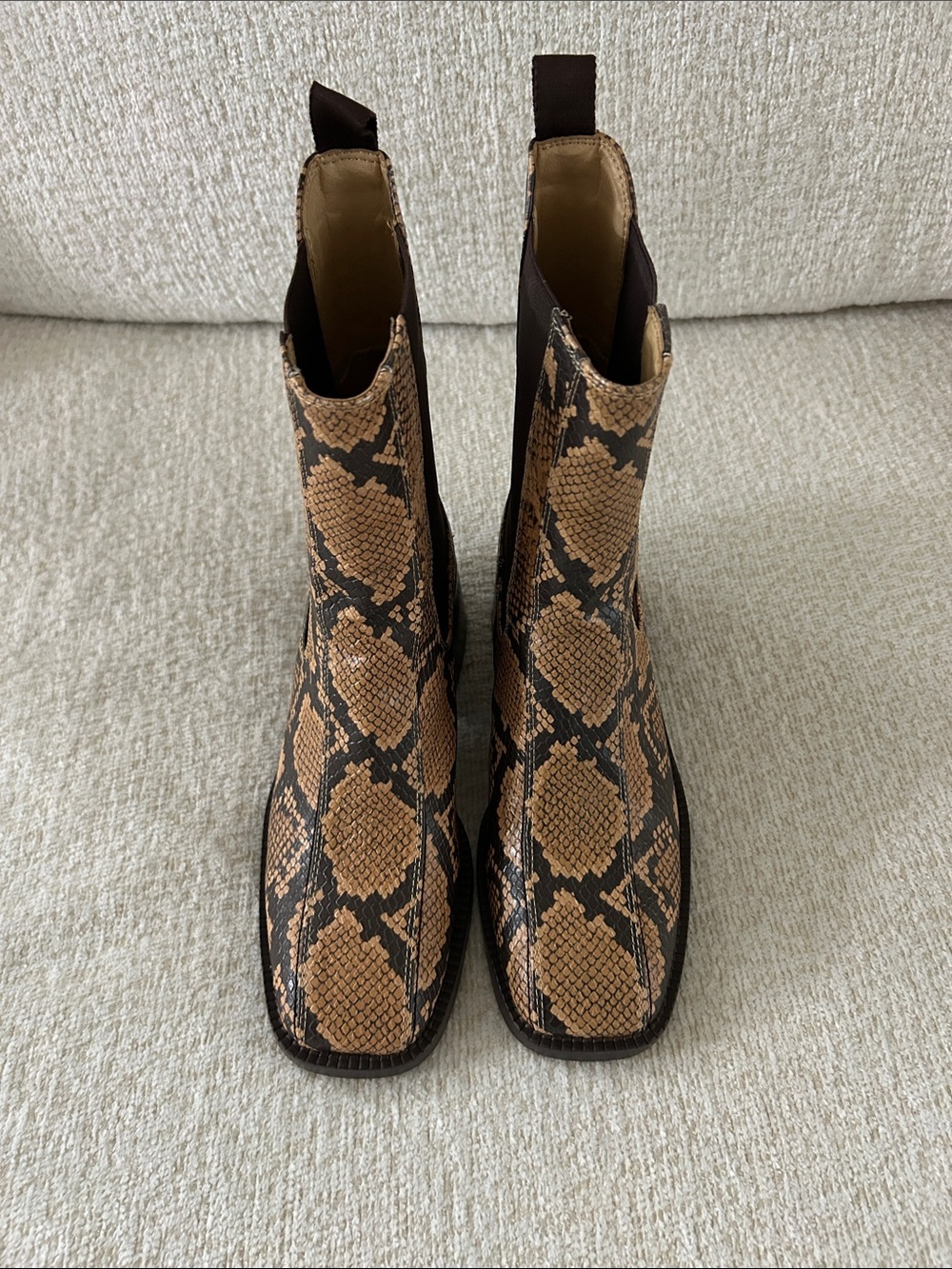 Sam Edelman Snake-Print Chelsea Ankle Boots in Tan and Black.